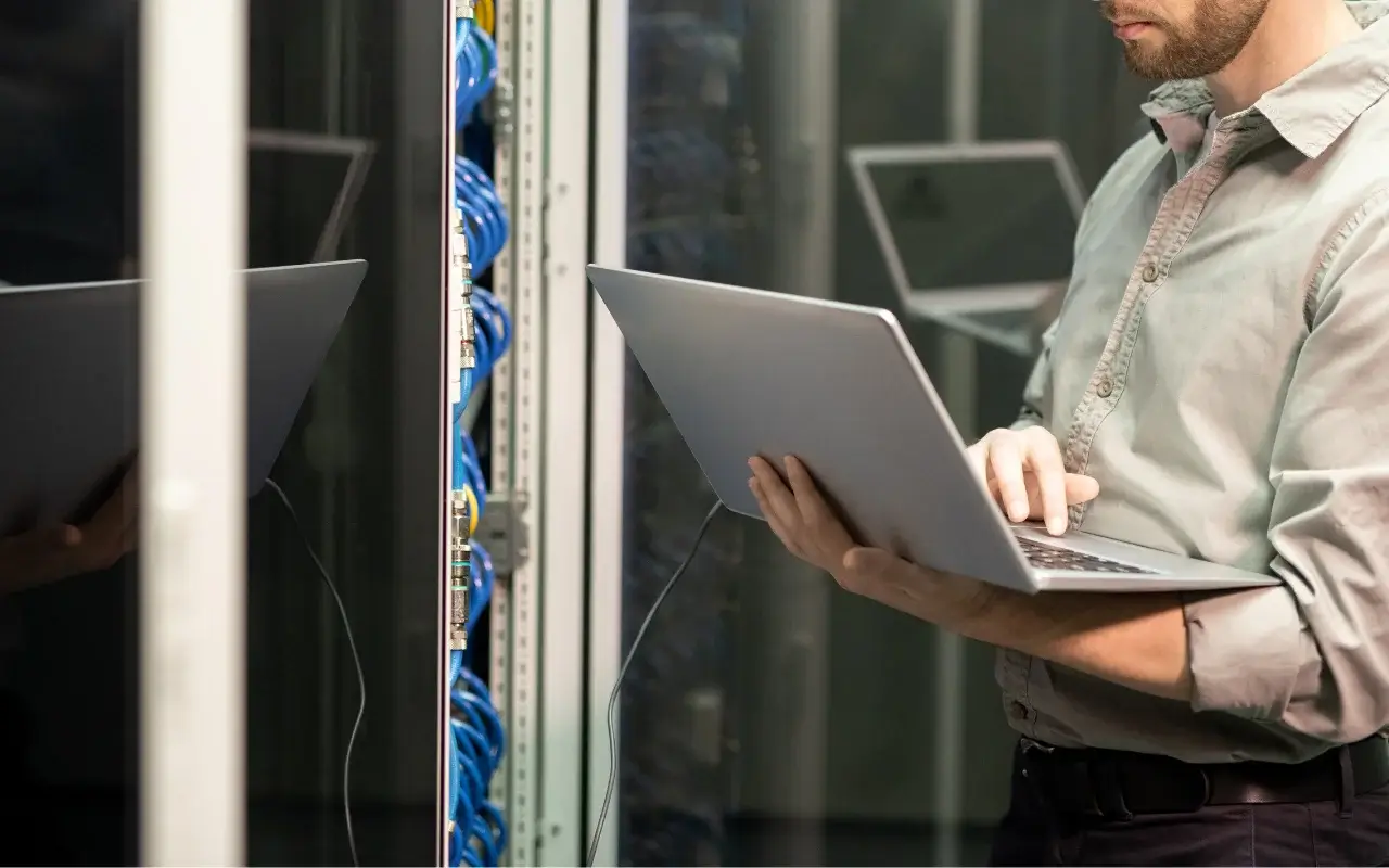 IT technician providing support through a laptop, representing managed services
