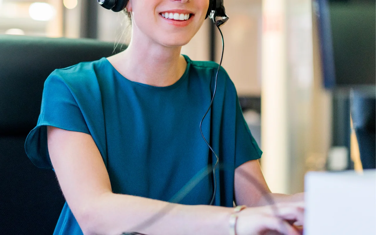 Help desk representative talking on a headset, offering basic technical support to a user